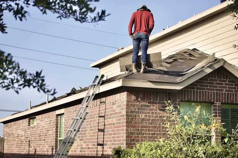 Professional roofer working on a residential roof in Nissequogue